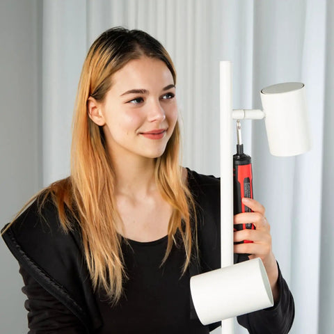 Woman using 4V Cordless Electric Screwdriver Kit With LED Work Light, 6 Torque Settings on lamp assembly