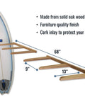 Side view of a vertical timber wall rack showing dimensions and cork-padded arms holding a surfboard.