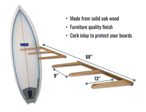 Side view of a vertical timber wall rack showing dimensions and cork-padded arms holding a surfboard.