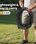 Black garden hose, 50 ft, coiled with brass connectors, held outdoors