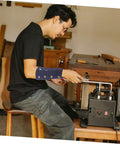 Man using a tool with Heavy Duty Cut Resistant Wrist Sleeves For Men And Women Beefy Arm Guards featuring abrasion block cover.