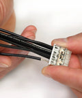 Hands using Push Wire Splicing Connector Wall Nuts For Solid And Stranded Conductors Eight Conductor With Light Gray Cover Tool Free Wiring
