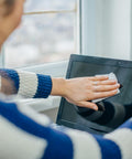 Person using Alcohol Wipes For Electronics With 70 Percent Isopropyl Alcohol, Quick Dry Tech Cleaning Wipes For Computers iPhones And Household Gear