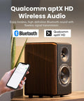 Person connecting phone via Bluetooth to S2000MKIII High Fidelity Studio Monitor Speakers with Coaxial Tweeter, shown in walnut finish.