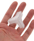 Hand holding clear PVC corner protector from 20 Pcs PVC Corner Protectors For Furniture Safety Edge Guards For Wardrobe Cabinets Desks And Tables Clear Discreet Protectors That Keep Edges Safe From Dings And Injuries Kid Safe Easy Install No Mess Non Slip Soft Shield pack