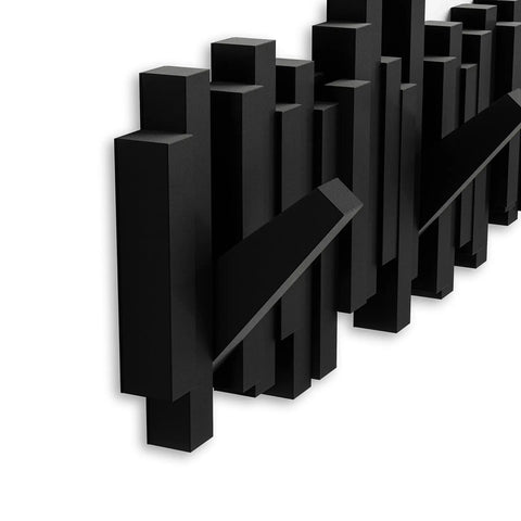 Close-up of Sticks Wall Mounted Coat Rack with five retractable pegs in slick black finish, ideal for entryway, bedroom, or office.