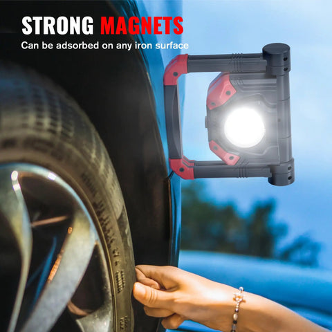 2Pack Rechargeable LED Work Light With Magnetic Bases used for tire repair, showing strong magnet holding to wheel