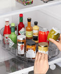 Smooth Spin Rectangular Lazy Susan Turntable Keeps Your Kitchen Super Slick And Totally Stress Free For Fridge Condiments Spices Pantry Jars And Countertop Organization Without Any Fuss in a fridge, holding various sauce bottles.