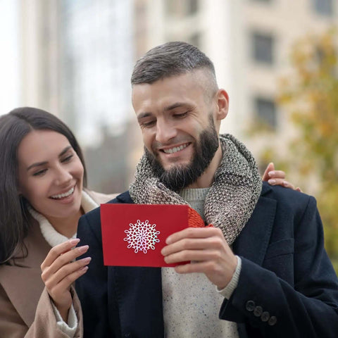 Couple holding a greeting card made with 8 Pattern Round Lace Border Die Set For Card Making And Paper Crafting With Dope Floral Motifs
