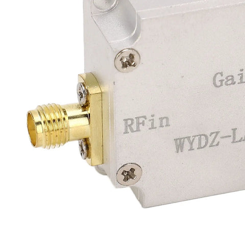 Close-up of Low Noise RF Amplifier 10 MHz To 6 GHz 20 DB LNA With High Flatness SMA female input in aluminum alloy housing.