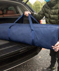 Person loading Massive 46 Inch Extra Large Zippered Duffel Bag For Travel Camping And Sports Gear Storage Waterproof