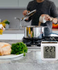 Tractor Farm Alarm Clock With LED Display And 7 Color Night Light, compact on kitchen counter with cooking scene in background