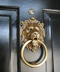 Vintage Brass Lion Door Knocker And Gate Pull With Solid Brass Finish Embossed Lion Mouth Design Traditional Door Accessory For Home Decor Entryway Accent 7 X 4 X 2 Inch mounted on a black door.