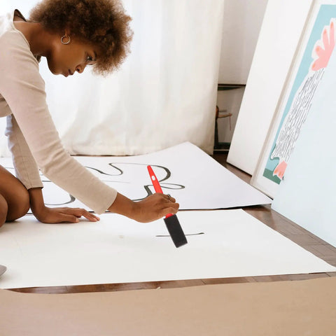 Woman using a brush from the No Sweat Home Painting Kit Featuring Quick Coverage Sponge Rollers Combined With Versatile Bristle Brushes.