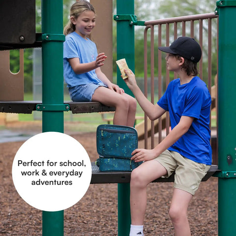 Kids at playground sharing snacks with Badass Pixel Camo Soft Sided Cooler Lunch Bag With Two Ice Packs And Six Hours Of Fridge Cold Chill For The Daily Grind Or Weekend Haul Insulated Carryall Keeping Your Eats Froze And Ready To Roll Anywhere.