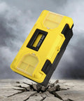 16 Inch Plastic Toolbox With Handle Portable Toolbox With Removable Tray And Lockable Design Built Tough For Home Workshop Or Garage With Small Parts Box In Black And Yellow on cracked concrete surface.