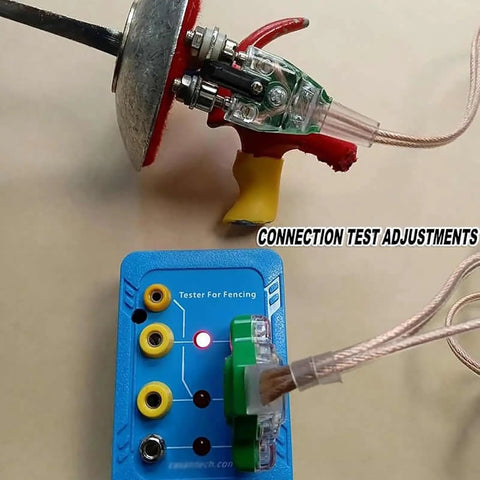 Fencing Gear Diagnostic Tool with color-coded slots and indicator lights testing an epee blade for maintenance.