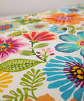 Close-up of bright floral indoor outdoor tufted wicker chair pad fabric with ties, featuring blue purple Gregoire pattern.