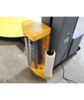 Heavy Duty Industrial Pre Stretch Wrapping Machine With Built In Scale And Thermal Label Printer No Sweat Operation Killer Five Thousand Pound Capacity Straight Shooter Wrap System side view of material holder