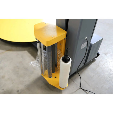 Heavy Duty Industrial Pre Stretch Wrapping Machine With Built In Scale And Thermal Label Printer No Sweat Operation Killer Five Thousand Pound Capacity Straight Shooter Wrap System side view of material holder