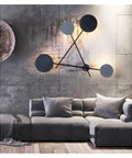 Top Shelf Round Led Wall Sconce Lighting For Bedroom Bedside Decor Featuring Smooth 360 Degree Rotation Matte Black Iron Industrial Loft Fixture Serving Clean Soft Glow mounted above a gray sectional sofa