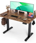 Claiks Electric Height Adjustable Standing Desk 40 By 24 Inches Rustic Brown surface with monitor, keyboard, and accessories.