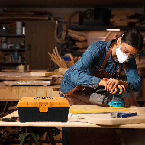 Rugged Multilayer Plastic Toolbox With A Secure Snap Latch And Spacious Yet Compact Shape, used by a tradesperson in a workshop.
