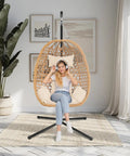 Cozy Hanging Egg Chair With Stand And Plush Cushions for indoor outdoor chill sessions in a modern boho style room.