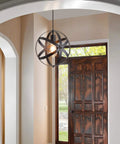 Farmhouse Black Globe Cage Pendant Light With Industrial Rustic Metal Look in entryway above door, E26 1 light fixture