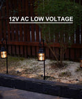Three Awesome Four Pack Low Voltage Outdoor Hanging Path Lights Kit Warm White Led Metal Shepherd Hook Lights along a pathway.
