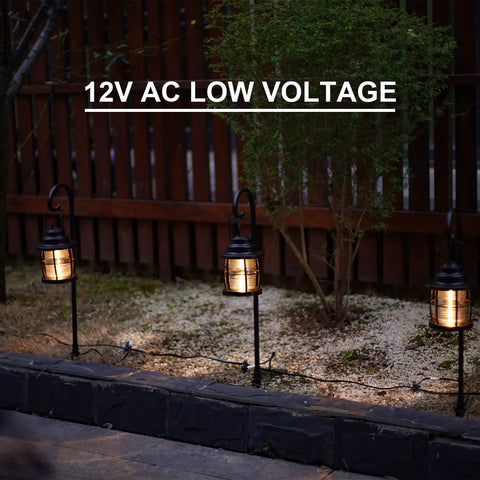 Three Awesome Four Pack Low Voltage Outdoor Hanging Path Lights Kit Warm White Led Metal Shepherd Hook Lights along a pathway.