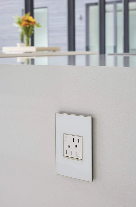Tamper-Resistant Self-Test GFCI Outlet 15A White Finish with matching wall plate in modern kitchen setting