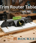 Pro Grade Adjustable Trim Router Table For Woodworking with high visibility bit guard and pre-drilled back holes on workbench.