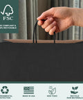 Hand holding 400 Pack Black Paper Gift Bags 16x6x12 Inches With Handles Made From Recycled Kraft Paper Eco Friendly Bulk Bags