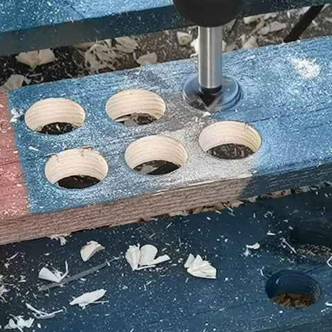 Woodworking hinge-boring drill bits set in a blue jig; six drilled circular holes in a wooden block