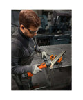 User operates Compact Cordless Angle Grinder With Brushless Motor And 18 Volt Battery Compatibility, cutting metal with sparks flying.
