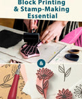 Person using brayer with All In One Printmaking And Stamp Making Kit For Beginners With Linoleum Blocks Ink and designs.
