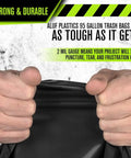 Close-up of hands gripping Heavy Duty 95 And 96 Gallon Garbage Bags 50 Pack With Bulletproof 2 Mil Thickness showing durability.