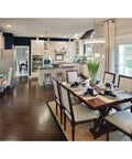 Modern kitchen with One Light Fresnel Glass Coastal Pendant in Brushed Nickel, island seating, and dark wood flooring.