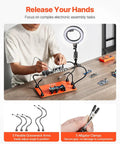 Person using Magnetic Helping Hands Soldering Station 2 In 1 With 3X LED Magnifying Lamp, with 5 flexible arms and PCB holders on desk.
