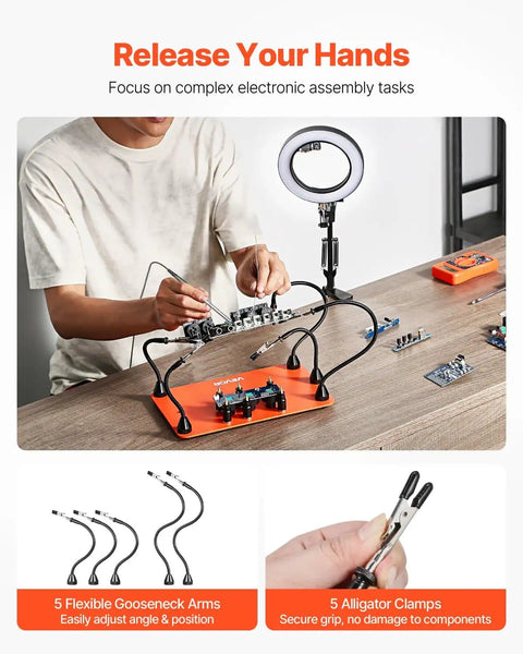 Person using Magnetic Helping Hands Soldering Station 2 In 1 With 3X LED Magnifying Lamp, with 5 flexible arms and PCB holders on desk.