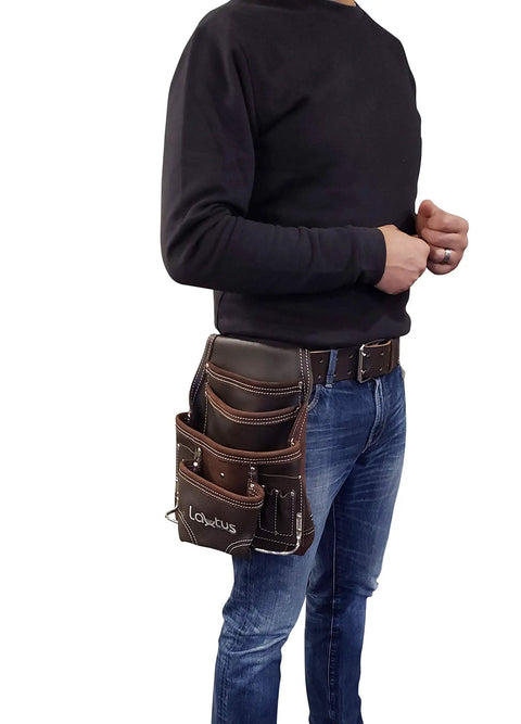 Person wearing Oil Tanned Leather Tool Pouch Bag For Carpenters And Handymen With 10 Pockets And 2 Hammer Holders 100 Percent Leather