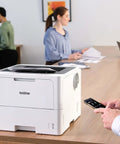 Office Printing Powerhouse Fast 50 Pages Per Minute Monochrome Laser Printer With Wireless Networking And Duplex Auto-Printing on desk