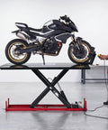 VEVOR Motorcycle Lift Table, 1500 Lb Electric Hydraulic Scissor Jack with a motorcycle on a raised platform in a workshop.
