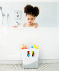Freestanding Bath Toy Drying Bin With Quick Drain Base, Real No Mess Game Changer For Keeping Kids Toys Snappy And Mold Free, slick gray plastic caddy filled with colorful bath toys in a bathtub setting.
