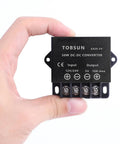 Hand holding DC 12V/24V To 5V 10A Step Down Converter For Car Audio And 5V Gadgets 50W Power Regulator with auto protection.