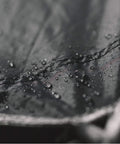 Close-up of waterproof ripstop nylon with taped seams, part of a Waterproof Hammock Rain Fly Tarp With Stakes And Carry Bag for camping.