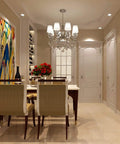 Dining room with elegant chandelier, art on wall, and chairs, lit by GU10 LED Bulbs 4W Non Dimmable 400 Lumens 2700K Warm White.