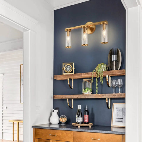 Brushed Gold 3 Light Vanity Light Fixture for Bathroom and Hallway Brass Bath Lighting with Glass Cylinders on dark wall