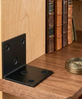 Rock Solid Built Tough Heavy Duty Black Stainless Steel L Brackets 4 Pack Wall Mount Shelf Supports For Furniture Wood Shelving Rustproof Workhorse For Kitchen Cabinets And Vanities Prime Grade Hardware on a wooden shelf.